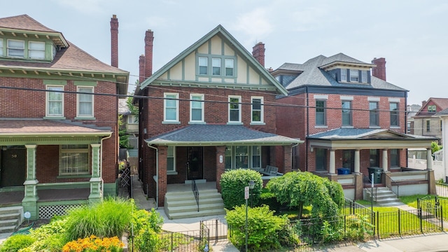 56 S Champion Ave, Columbus, OH 43205 - view of front of property with covered porch, a fenced front yard, and brick siding