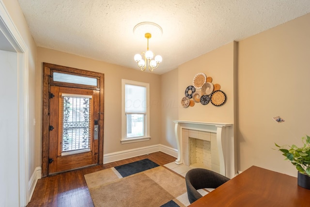 56 S Champion Ave, Columbus, OH 43205 - entryway featuring wood finished floors, a chandelier, and a textured ceiling