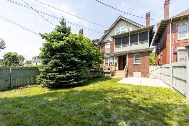 56 S Champion Ave, Columbus, OH 43205 - back of house featuring brick siding, a fenced backyard, a wooden deck, a patio area, and a chimney