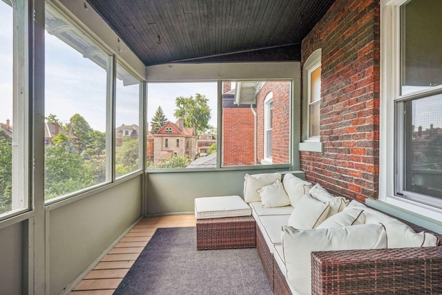 56 S Champion Ave, Columbus, OH 43205 - sunroom featuring plenty of natural light, wood finished floors, outdoor lounge area, lofted ceiling, and brick wall