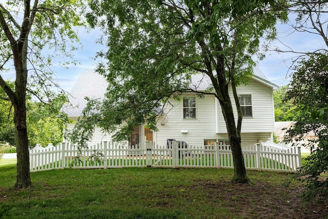 6838 Evergreen Cir, Dayton, OH 45424 - rear view of house featuring roof with shingles, a fenced front yard, and an attached garage