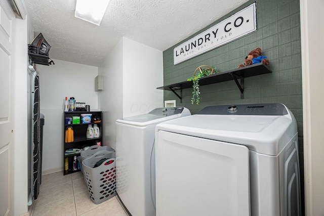 6838 Evergreen Cir, Dayton, OH 45424 - laundry room with separate washer and dryer, light tile patterned flooring, and a textured ceiling