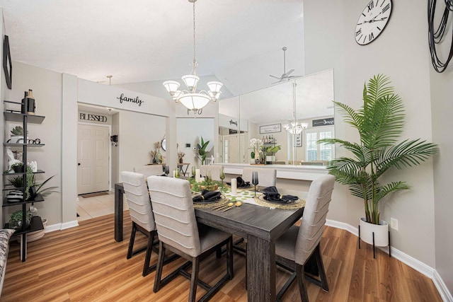 6838 Evergreen Cir, Dayton, OH 45424 - dining space featuring a chandelier, light wood-style floors, and vaulted ceiling