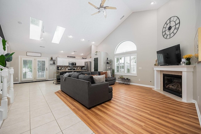 6838 Evergreen Cir, Dayton, OH 45424 - living area featuring high vaulted ceiling, a tiled fireplace, ceiling fan, light tile patterned floors, and recessed lighting