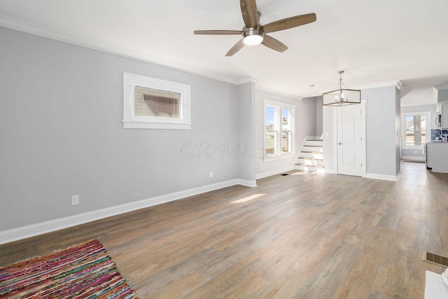 670-672 E Jenkins Ave, Columbus, OH 43207 - unfurnished living room with ornamental molding, healthy amount of natural light, ceiling fan, wood finished floors, and a chandelier