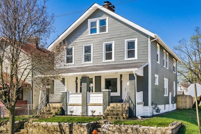 670-672 E Jenkins Ave, Columbus, OH 43207 - american foursquare style home featuring a porch and a chimney
