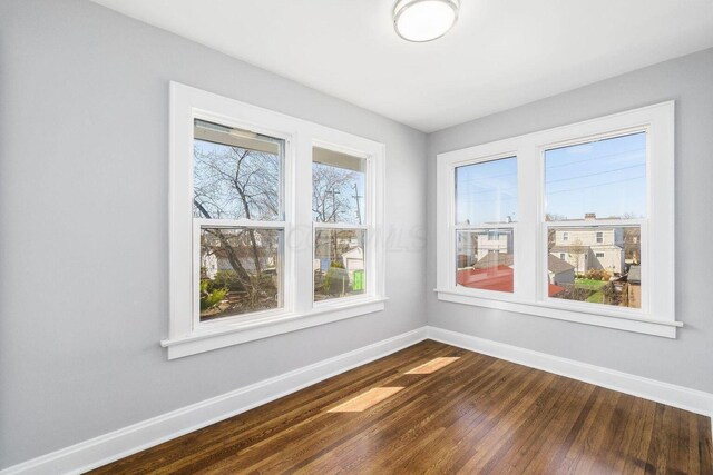 670-672 E Jenkins Ave, Columbus, OH 43207 - unfurnished room featuring baseboards and dark wood-style flooring