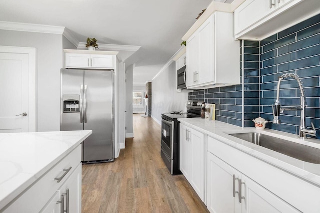 670-672 E Jenkins Ave, Columbus, OH 43207 - kitchen with stainless steel appliances, crown molding, light wood finished floors, backsplash, and white cabinetry