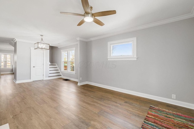 670-672 E Jenkins Ave, Columbus, OH 43207 - empty room featuring plenty of natural light, ornamental molding, wood finished floors, and stairs