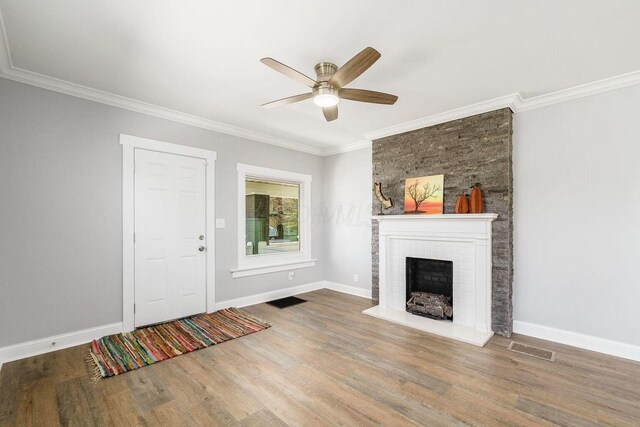 670-672 E Jenkins Ave, Columbus, OH 43207 - unfurnished living room with wood finished floors, ceiling fan, a fireplace, and crown molding