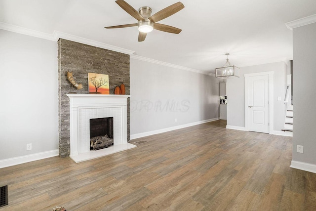 670-672 E Jenkins Ave, Columbus, OH 43207 - unfurnished living room with a fireplace with raised hearth, ceiling fan, wood finished floors, a chandelier, and crown molding