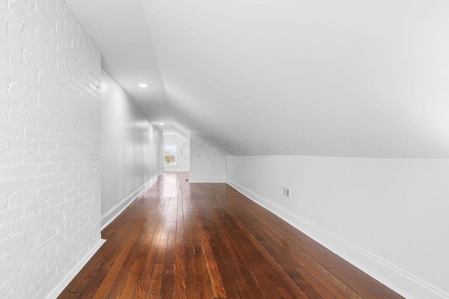 670-672 E Jenkins Ave, Columbus, OH 43207 - bonus room featuring hardwood / wood-style floors, lofted ceiling, and brick wall