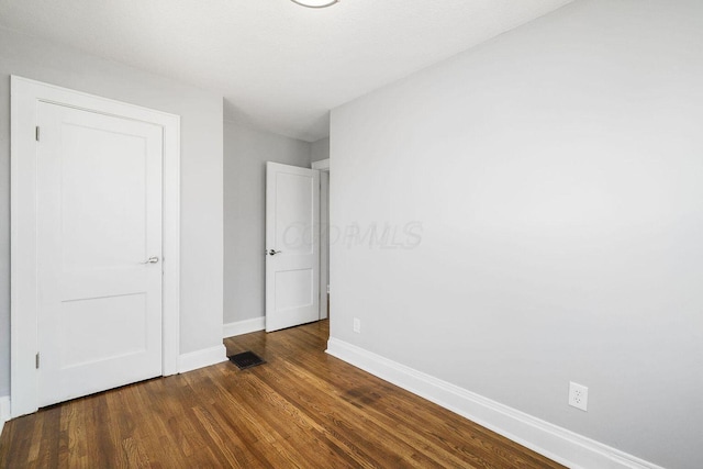 670-672 E Jenkins Ave, Columbus, OH 43207 - unfurnished bedroom with baseboards and dark wood-type flooring