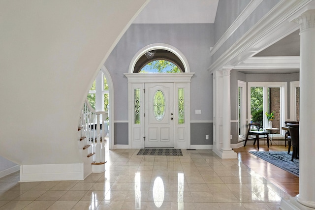 3917 Tarrington Ln, Columbus, OH 43220 - foyer entrance featuring decorative columns, light tile patterned flooring, and a high ceiling