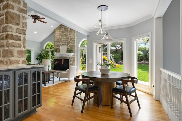 3917 Tarrington Ln, Columbus, OH 43220 - dining space with a stone fireplace, plenty of natural light, light wood-style flooring, lofted ceiling, and ceiling fan