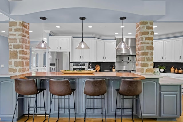 3917 Tarrington Ln, Columbus, OH 43220 - kitchen featuring appliances with stainless steel finishes, tasteful backsplash, white cabinets, dark countertops, and a spacious island