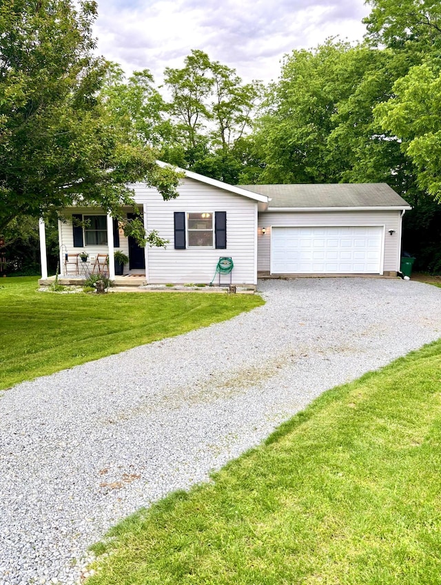 158 Kennedy Blvd, Leesburg, OH 45135 - view of front of house with driveway, a front lawn, an attached garage, and covered porch