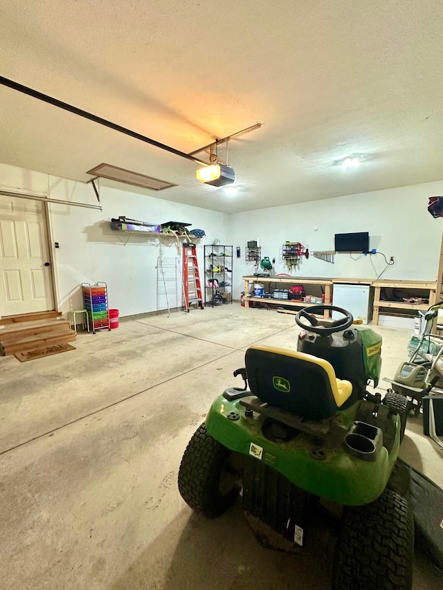158 Kennedy Blvd, Leesburg, OH 45135 - garage featuring a garage door opener and fridge
