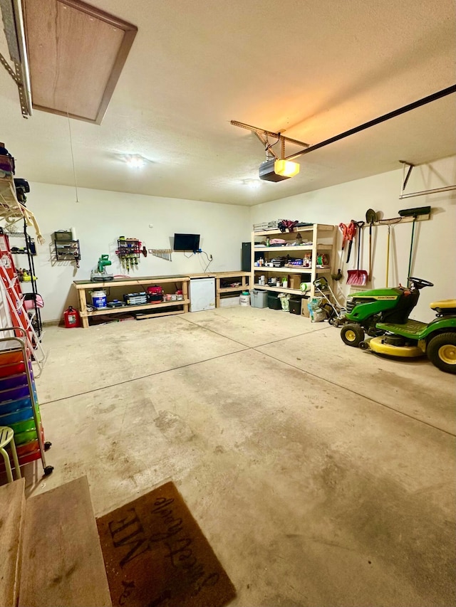 158 Kennedy Blvd, Leesburg, OH 45135 - garage featuring a garage door opener and fridge