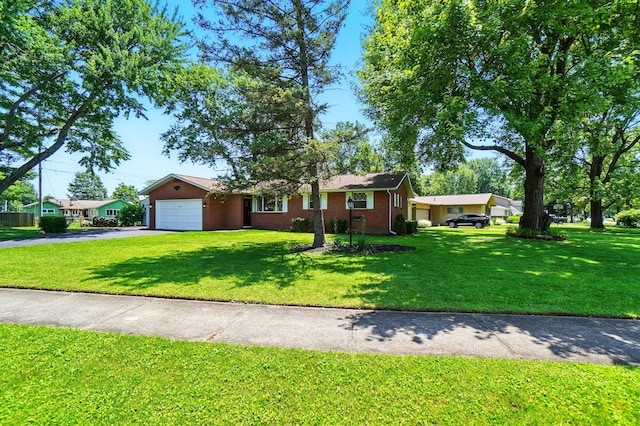 248 Grandview Ave, Delaware, OH 43015 - ranch-style house with asphalt driveway, a front lawn, an attached garage, and brick siding