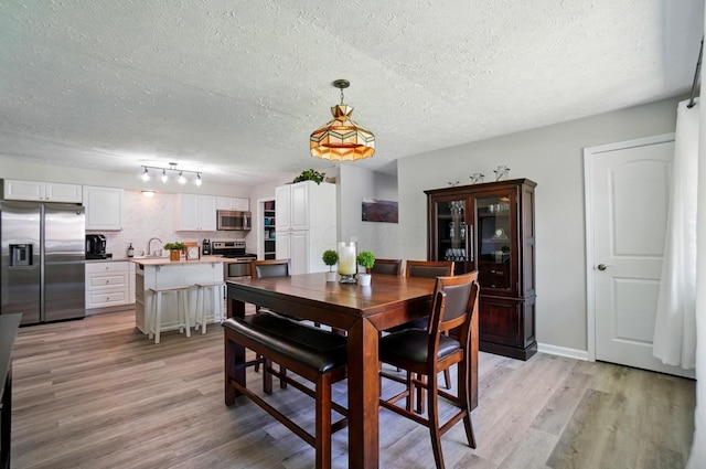 248 Grandview Ave, Delaware, OH 43015 - dining room with a textured ceiling and light wood finished floors