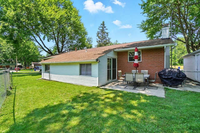 248 Grandview Ave, Delaware, OH 43015 - rear view of house featuring a fenced backyard, a patio area, a chimney, and brick siding