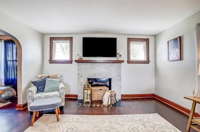 6997 State Route 734, Jamestown, OH 45335 - living room featuring hardwood / wood-style flooring, a fireplace, and arched walkways