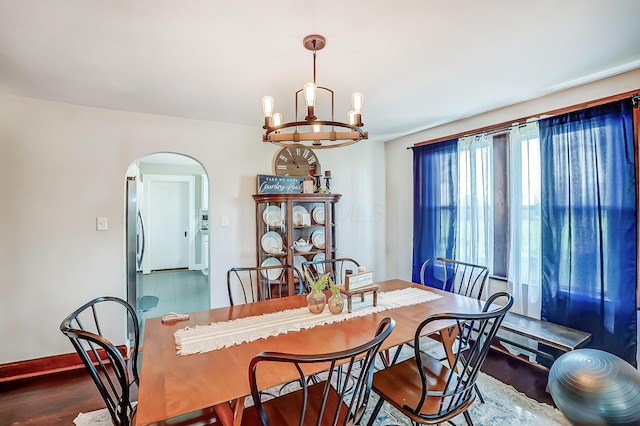 6997 State Route 734, Jamestown, OH 45335 - dining room with arched walkways, a chandelier, and wood finished floors