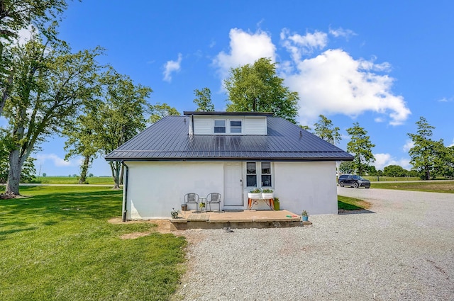 6997 State Route 734, Jamestown, OH 45335 - back of house with stucco siding, a yard, and a metal roof