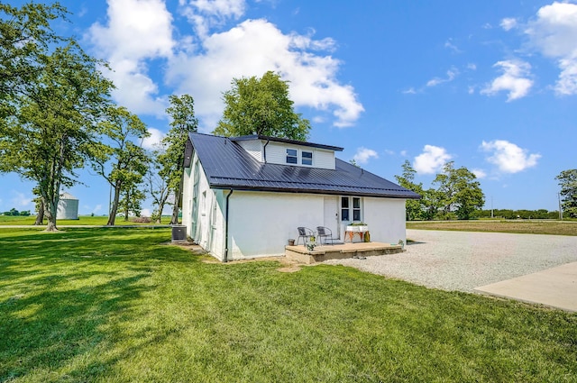 6997 State Route 734, Jamestown, OH 45335 - rear view of property featuring a yard, stucco siding, and a metal roof