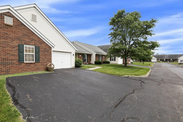 1104 Arbor Oaks Ln, Galloway, OH 43119 - view of front of house with brick siding, driveway, and a front yard