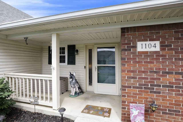1104 Arbor Oaks Ln, Galloway, OH 43119 - view of exterior entry featuring covered porch and brick siding