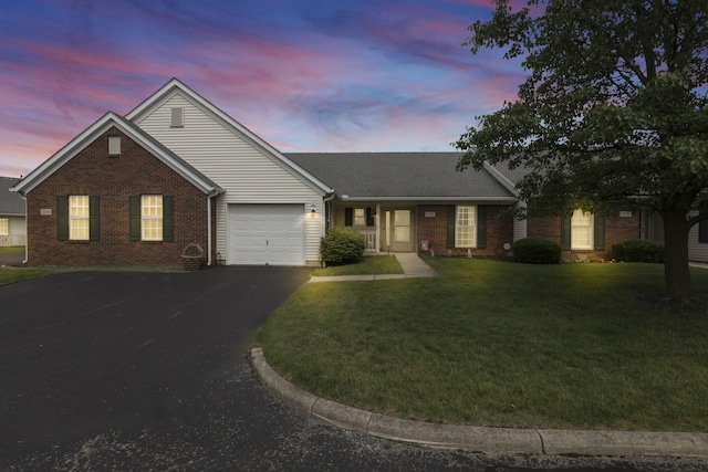 1104 Arbor Oaks Ln, Galloway, OH 43119 - ranch-style house with a garage, brick siding, asphalt driveway, and a lawn