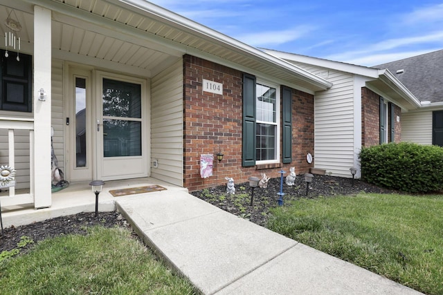 1104 Arbor Oaks Ln, Galloway, OH 43119 - view of exterior entry featuring brick siding and a porch