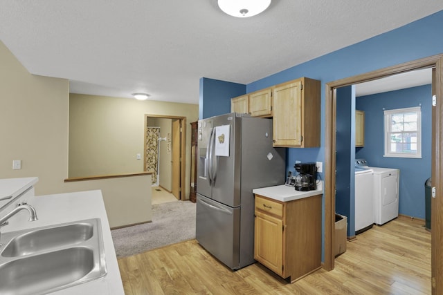 1104 Arbor Oaks Ln, Galloway, OH 43119 - kitchen with stainless steel fridge with ice dispenser, washing machine and clothes dryer, light wood-style flooring, light countertops, and a textured ceiling