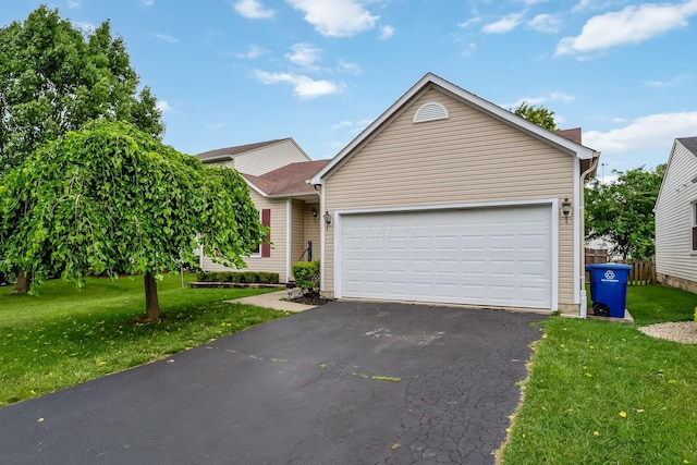 1344 Bluffton Ct, Columbus, OH 43228 - view of front of property featuring a front lawn, asphalt driveway, and a garage