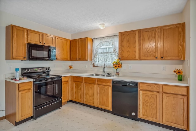 1344 Bluffton Ct, Columbus, OH 43228 - kitchen with black appliances, light countertops, a textured ceiling, light floors, and brown cabinetry