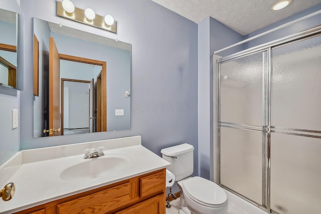 1344 Bluffton Ct, Columbus, OH 43228 - bathroom featuring a stall shower, vanity, and a textured ceiling