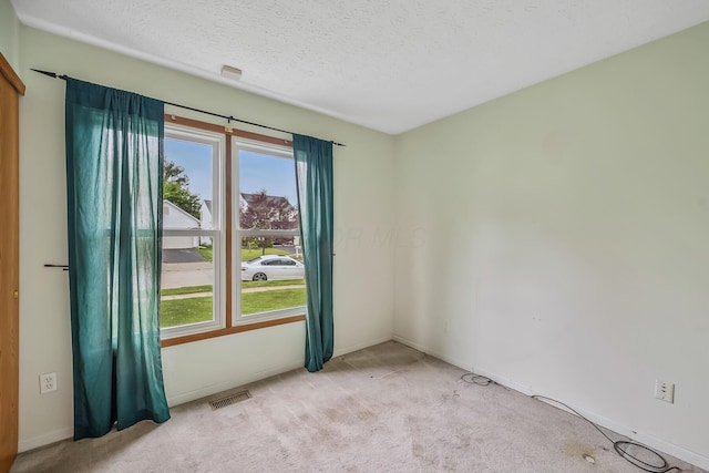 1344 Bluffton Ct, Columbus, OH 43228 - unfurnished room featuring healthy amount of natural light, light carpet, and a textured ceiling