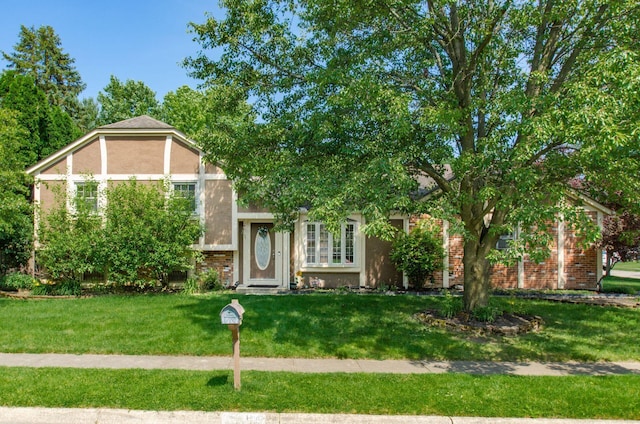 7484 Blue Fox Ln, Columbus, OH 43235 - view of front of home with a front lawn, stucco siding, and brick siding