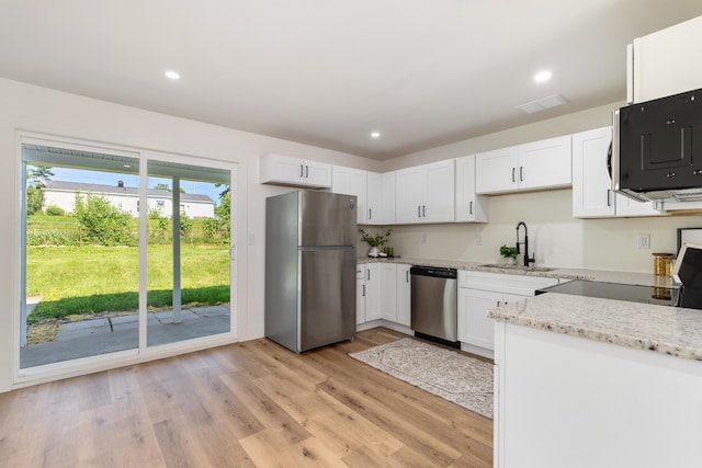 540 Mohawk Dr, Lancaster, OH 43130 - kitchen with appliances with stainless steel finishes, light stone countertops, white cabinets, light wood-style floors, and recessed lighting