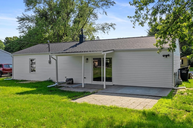 540 Mohawk Dr, Lancaster, OH 43130 - rear view of house featuring a lawn, a patio, a chimney, and a shingled roof