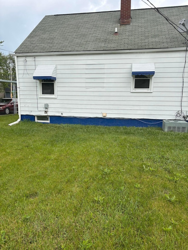 1155 E 26th Ave, Columbus, OH 43211 - view of home's exterior featuring a shingled roof, a yard, and a chimney