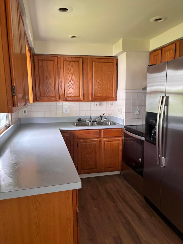 1155 E 26th Ave, Columbus, OH 43211 - kitchen featuring appliances with stainless steel finishes, brown cabinets, dark wood-style flooring, and backsplash