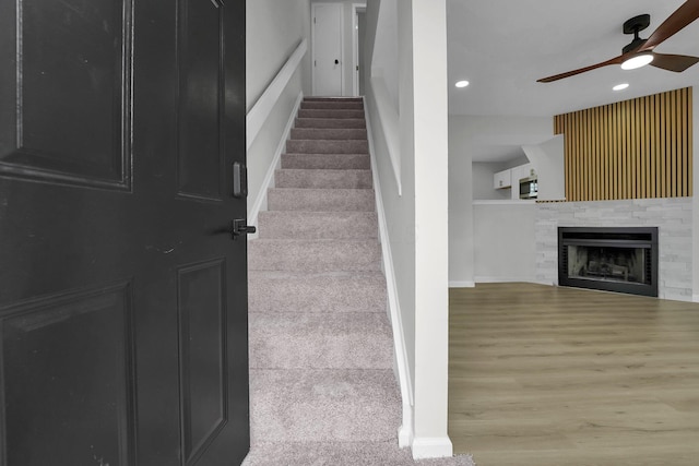 840 Pine Way Dr Unit D2, Columbus, OH 43085 - staircase featuring ceiling fan, recessed lighting, a tile fireplace, and wood finished floors