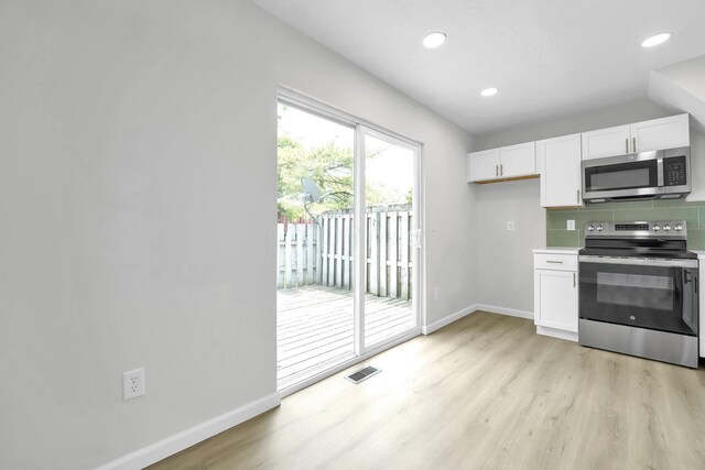 840 Pine Way Dr Unit D2, Columbus, OH 43085 - kitchen featuring stainless steel appliances, white cabinetry, light wood finished floors, tasteful backsplash, and recessed lighting