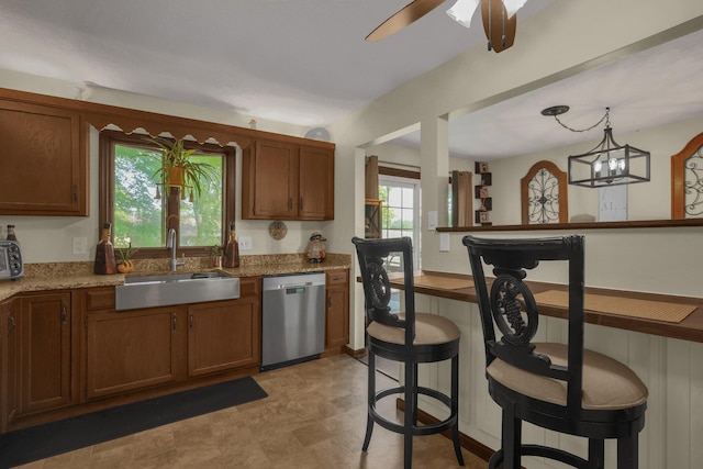 2542 Eckert Rd, Lexington, OH 44904 - kitchen with dishwasher, a kitchen bar, brown cabinetry, and ceiling fan