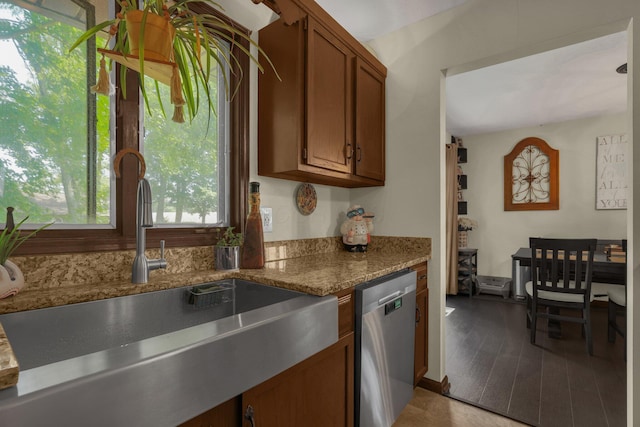 2542 Eckert Rd, Lexington, OH 44904 - kitchen featuring stainless steel dishwasher, brown cabinets, stone counters, and light wood-type flooring