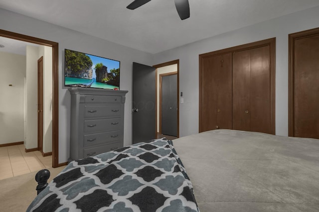 2542 Eckert Rd, Lexington, OH 44904 - bedroom featuring two closets, light tile patterned floors, ceiling fan, and light colored carpet