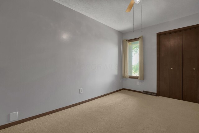 2542 Eckert Rd, Lexington, OH 44904 - unfurnished bedroom featuring light carpet, a closet, and ceiling fan